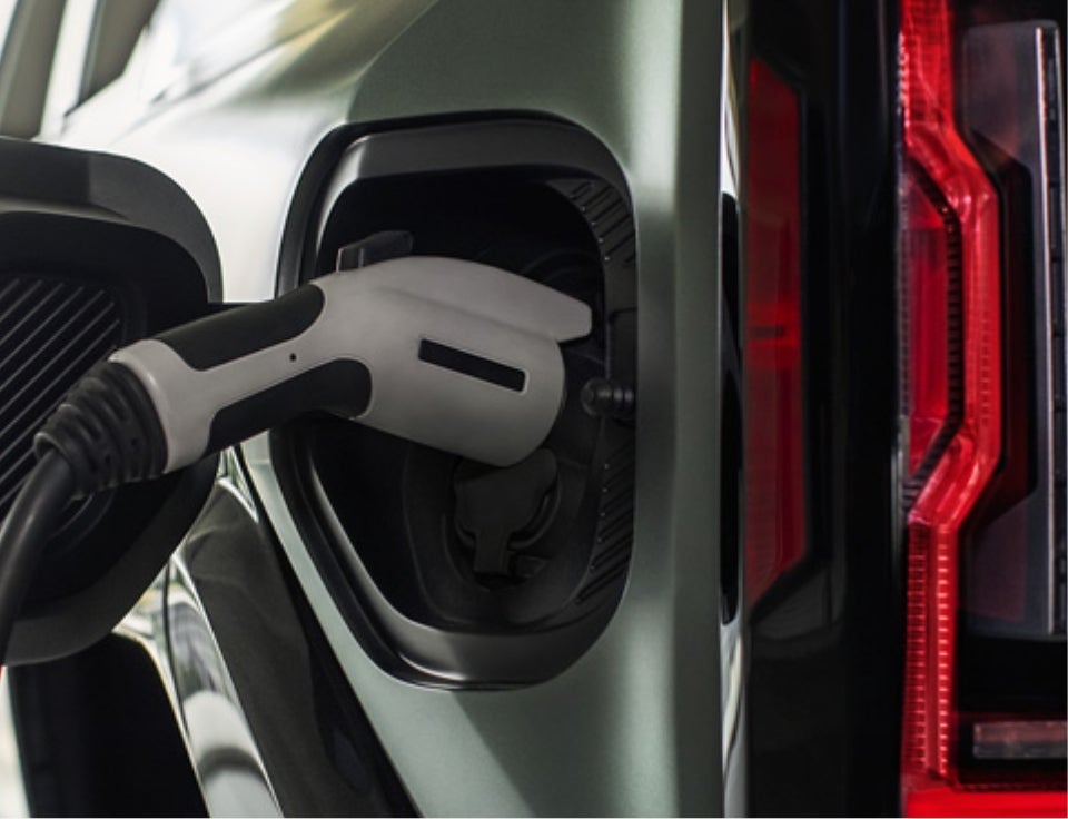 Close up of charging port with charger plugged in on a GMC Hummer EV SUV - Earnhardt Buick GMC in MESA AZ